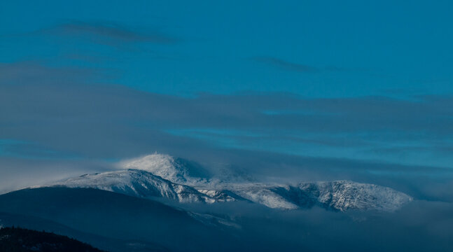 Mount Washington and at the summit The Mount Washington Observatory covered in snow and rime ice.