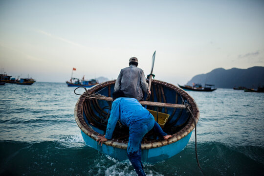 Fishermen head into the sea in southern Vietnam.