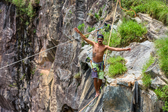 Man walking on slackline in Dibs Quarry, Maripora, Sao Paulo State, Brazil
