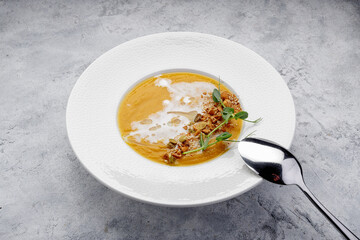 Pumpkin cream soup with seeds and nuts