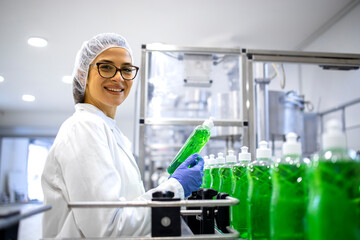 Portrait of female technologist controlling production of cleaning supplies or sanitation chemicals for cleaning industry. - obrazy, fototapety, plakaty