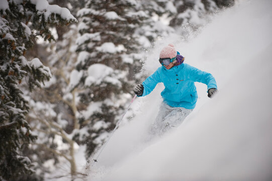 Woman skiing powder, Park City, Utah.