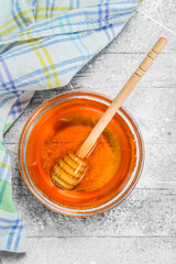 Natural honey in jar with wooden spoon.