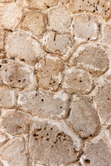 Sun-baked coral stone wall texture, facade of an old building in Dubai, United Arab Emirates.