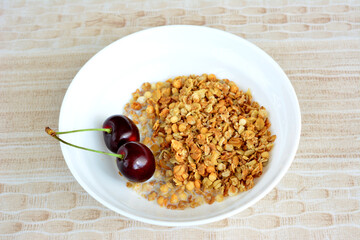 healthy breakfast with muesli, milk and berries in white bowl isolated, close-up