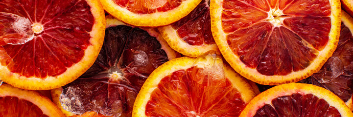 Fruit banner with blood oranges and ice, delicious sweet fruit, top view
