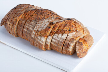 Fresh bread with carrots on the white table