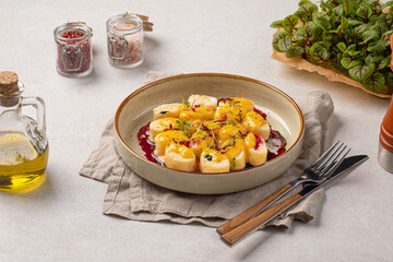 Portion of lazy dumplings with vanilla and cherry sauce