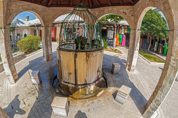 Fototapeta na wymiar Fountain-sadirvan inside in the courtyard of the Mosque Koski Mehmed Pasha, Mostar, Bosnia and Herzegovina