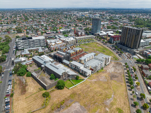 Aerial view of new apartment blocks around an old jail complex