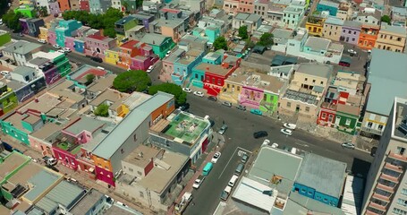A drone flies over a modern and beautiful South African city at sunset. Aerial view of Cape Town which is located on the ocean. One of the richest cities in Africa