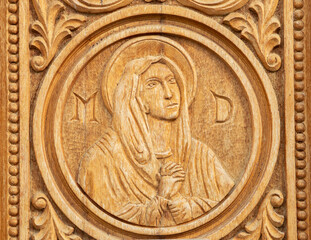A close-up of a wooden engraving representing the face of the Mother of God at the Dumbrava monastery - Romania