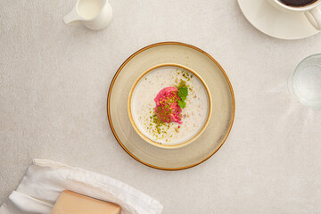 Portion of mixed cereal porridge with berry sorbet