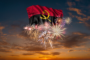 Flag of Angola and Holiday fireworks in sky