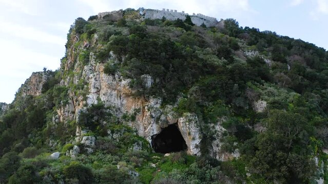Drone view of Nestor&rsquo;s Cave and ruins of Old Navarino Castle on the mountaintop