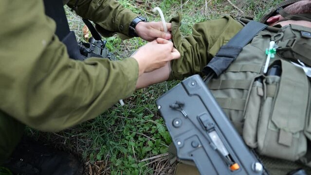 Israeli Army Soldier Provide First Aid On Battle Field - Applies a Tourniquet on Arm And Injects Needle