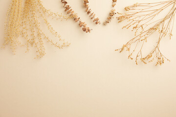 autumn mood with dried flowers and pastel beige background. flat lay and copy space