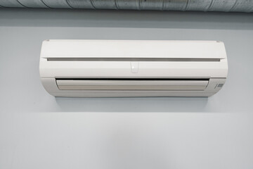 Air conditioner on gray wall room interior