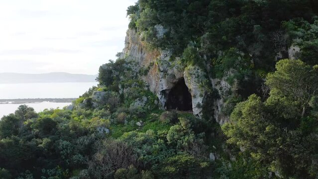 Drone view of entrance to Nestor&rsquo;s Cave and trees growing around it