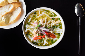 Chicken soup Pho ga  in vietnamese style on black background - obrazy, fototapety, plakaty