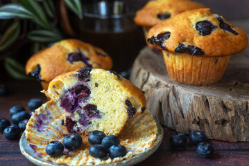 freshly baked homemade blueberry muffins on wooden table background.