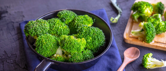 Close-up of green fresh vegetable broccoli. Fresh green broccoli on a pan. Broccoli vegetable is full of health. Vegetables for diet and healthy eating.Top view