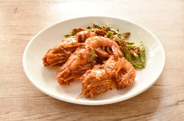 fried river shrimp with slice yard long bean in curry sauce on plate