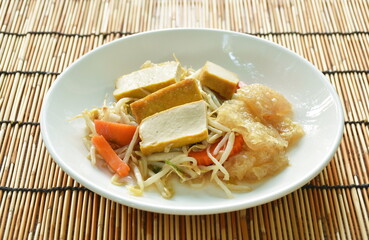 fried bean sprout with slice yellow tofu and pork skin on plate 