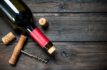 bottle of red wine with a corkscrew.