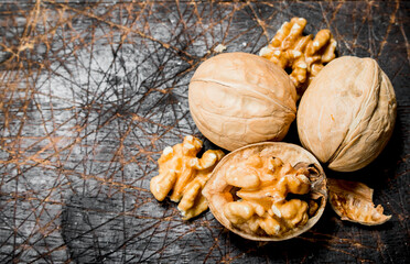 Peeled walnut on wooden board .