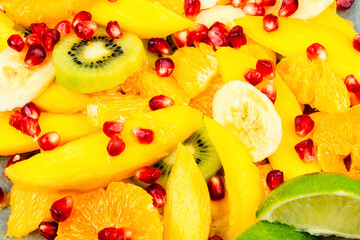 Fruit salad of citrus and berries, food background