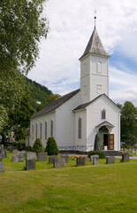 Fototapeta na wymiar The wooden church at √òystese, Western Norway, on the Hardanger Fjord.