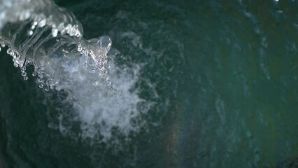 Irrigation water flow from pipe to canal for agriculture fields , slow motion water flash