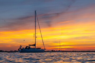 Sailing boat anchored with dramatic sunset