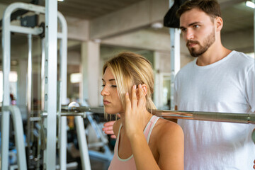 Fototapeta na wymiar Sport man trainning woman exercise lifting weight in sport gym