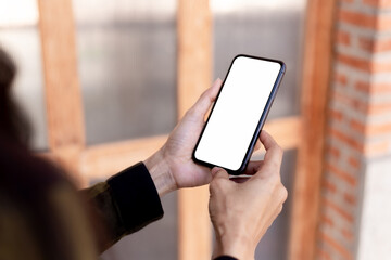 cell phone blank white screen mockup.hand holding texting using mobile on desk at office.background empty space for advertise.work people contact marketing business,technology
