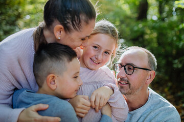 Portrait of happy family with kids in a forest.