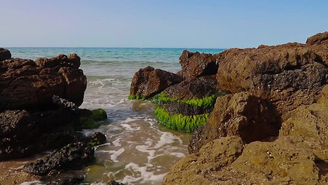 Waves hitting the rocks on the La Pineda beach in Salou Spain.
