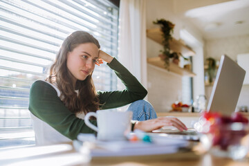 Young woman having homeoffice in her apartment.