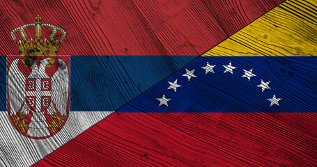 Background with flag of Serbia and Venezuela on wooden divided table. 3d illustration