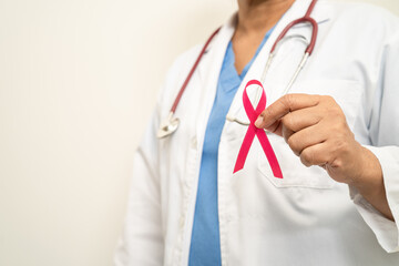 Breast cancer, Asian doctor woman with pink ribbon, symbol of World Breast Cancer Day.