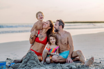Happy family with little kids enjoying time at sea in exotic country.