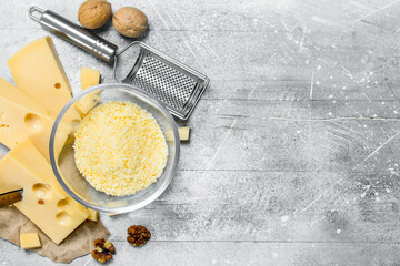 Grated cheese in a bowl with walnuts.