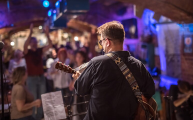 Band performs on stage, rock music concert.