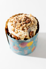 Top view of the traditional Easter cake decorated with white icing and nuts