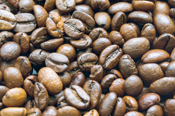 Roasted coffee beans brown background