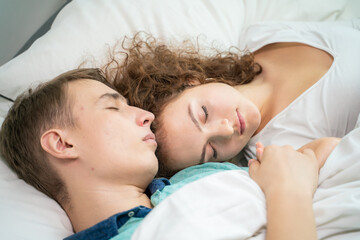 Lovely couple sleeping on white bed morning scene