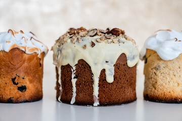 Preparation for the Christian holiday. Close-up of a handmade Easter cake with white chocolate on a light background
