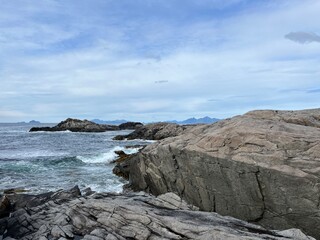 Fototapeta na wymiar Amazing rocky ocean bay, rocky coast, huge stones, seascape, cloudy sky, Nordic seascape