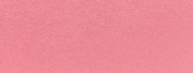 Texture of old dark pink color paper background, macro. Structure of a vintage craft rose cardboard.